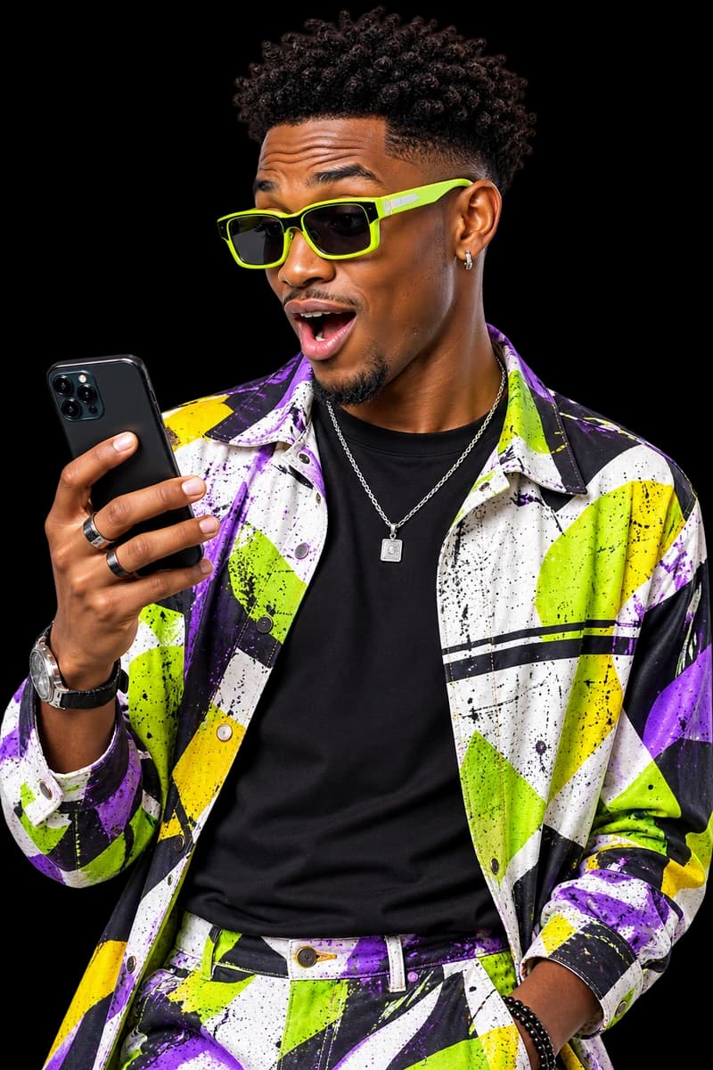 Man in lime sunglasses looking at his phone in surprise